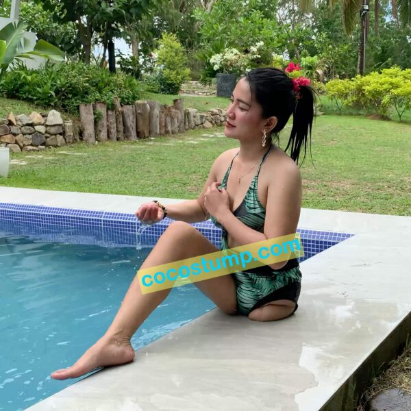 Megan in the pool wearing green swimsuit 4k