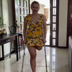 Kiara crutching in yellow dress